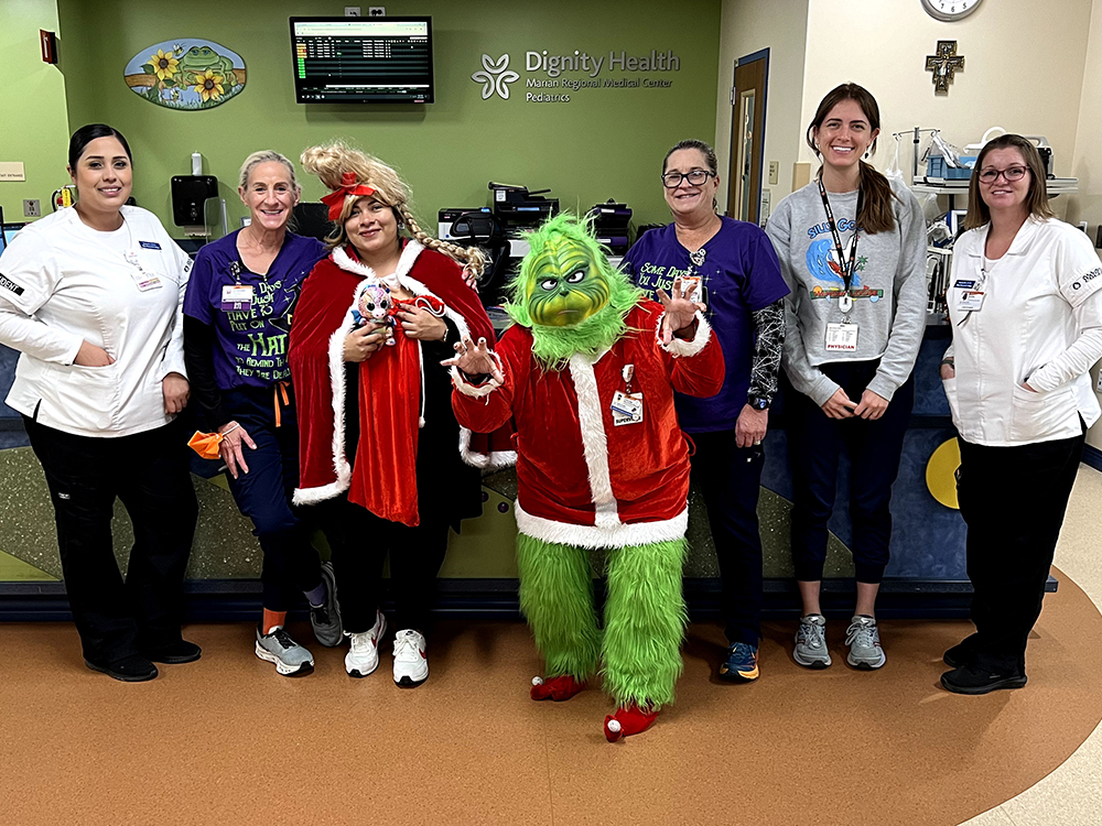 Marian Staff Posing with the Grinch