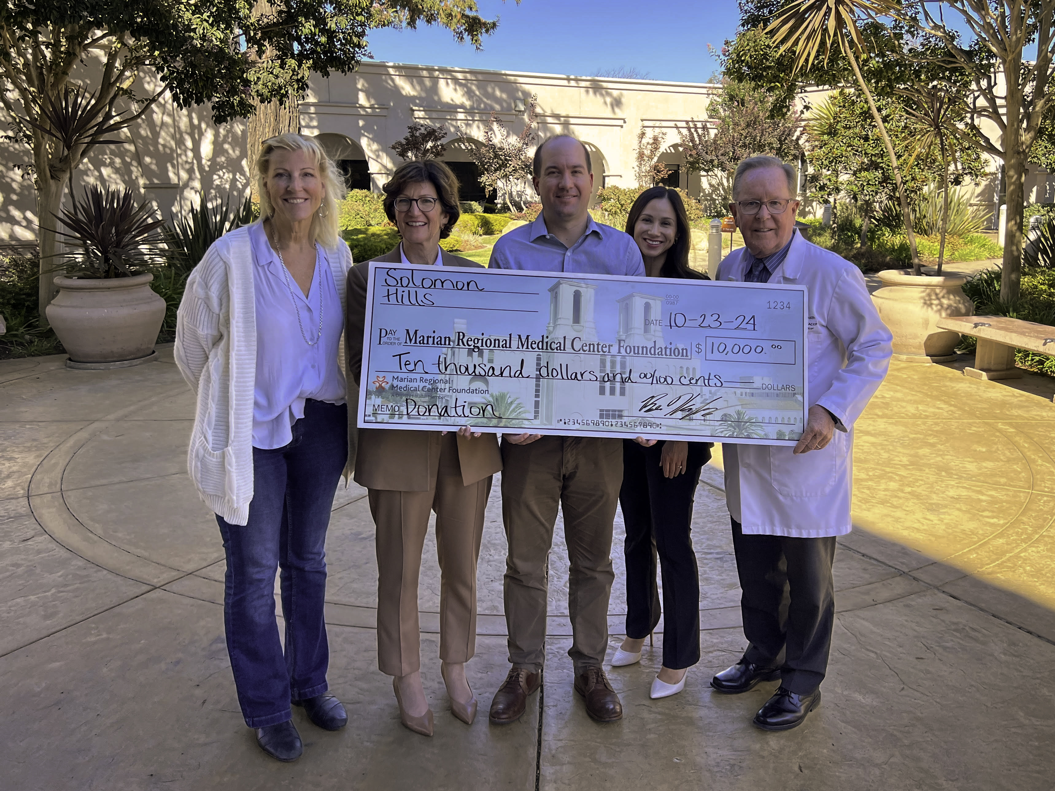 Solomon Hills Check Presentation with Marian Staff